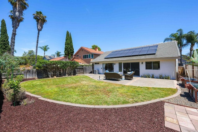 5452 Gooseberry Way, Oceanside, CA 92057 - back of house with solar panels, a fenced backyard, a patio, and an outdoor living space