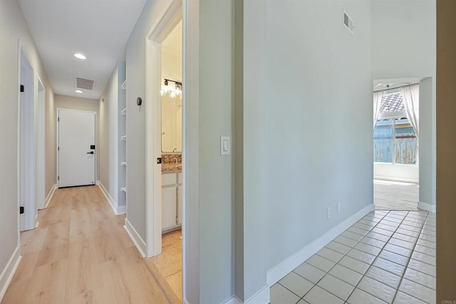 5452 Gooseberry Way, Oceanside, CA 92057 - corridor featuring built in shelves, light tile patterned flooring, and recessed lighting
