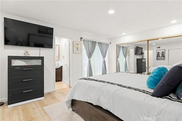 6002 Calvin Cir, Huntington Beach, CA 92647 - bedroom featuring light wood-type flooring, a closet, recessed lighting, and ensuite bathroom