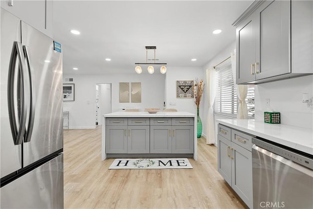6002 Calvin Cir, Huntington Beach, CA 92647 - kitchen featuring stainless steel appliances, gray cabinetry, light wood-type flooring, light countertops, and recessed lighting