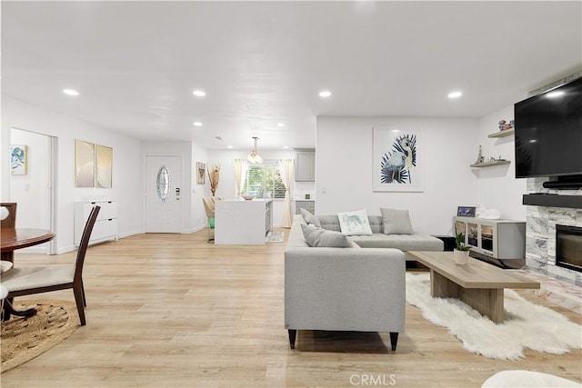 6002 Calvin Cir, Huntington Beach, CA 92647 - living room featuring light wood-style flooring, recessed lighting, and a premium fireplace
