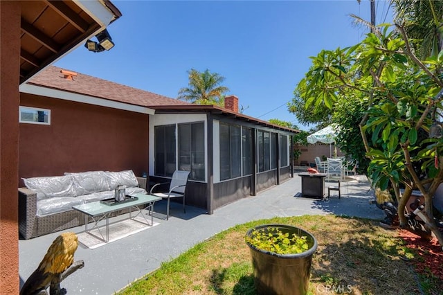 6002 Calvin Cir, Huntington Beach, CA 92647 - view of patio featuring a sunroom and an outdoor living space with a fire pit