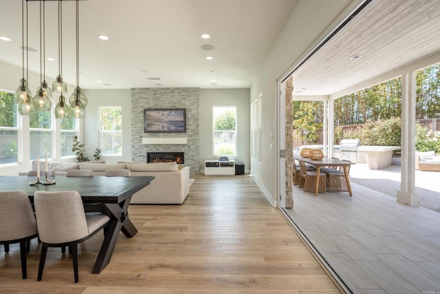 744 Adelaide Cir, Encinitas, CA 92024 - dining area with a fireplace, light wood-style floors, and recessed lighting