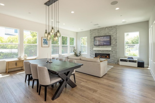 744 Adelaide Cir, Encinitas, CA 92024 - dining room with a fireplace, light wood-style flooring, and recessed lighting