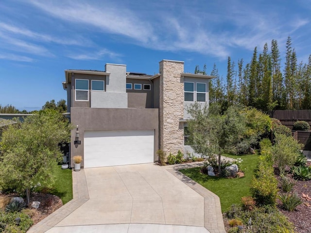 744 Adelaide Cir, Encinitas, CA 92024 - modern home featuring an attached garage, stucco siding, roof mounted solar panels, concrete driveway, and a chimney