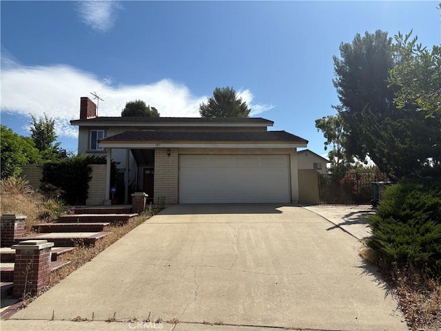 197 Limestone Rd, Claremont, CA 91711 - view of front facade with driveway, a garage, a chimney, and stucco siding