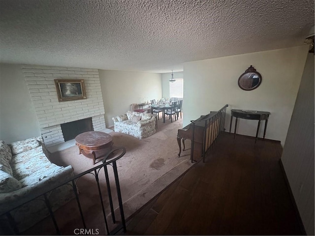 197 Limestone Rd, Claremont, CA 91711 - living room with wood finished floors, a textured ceiling, and a fireplace