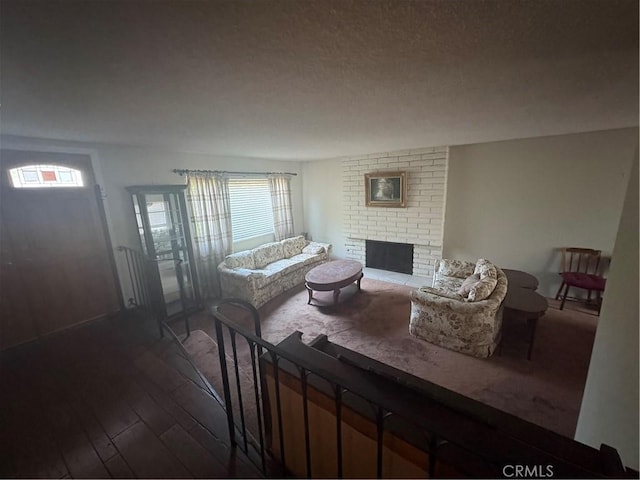 197 Limestone Rd, Claremont, CA 91711 - living room with dark wood finished floors, plenty of natural light, a fireplace, and a textured ceiling