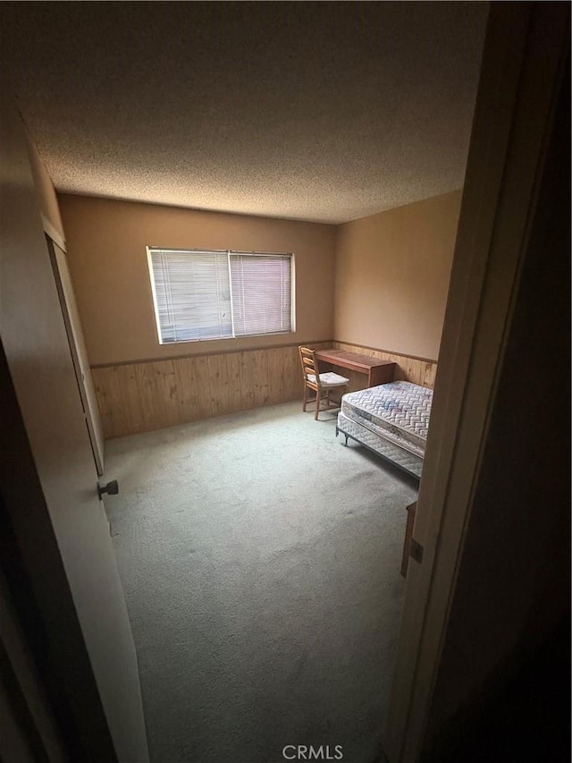 197 Limestone Rd, Claremont, CA 91711 - unfurnished bedroom with carpet, a textured ceiling, and wooden walls