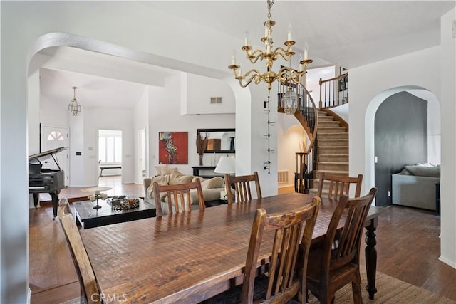 8042 Masefield Ct, West Hills, CA 91304 - dining space with arched walkways, wood finished floors, stairs, and a chandelier