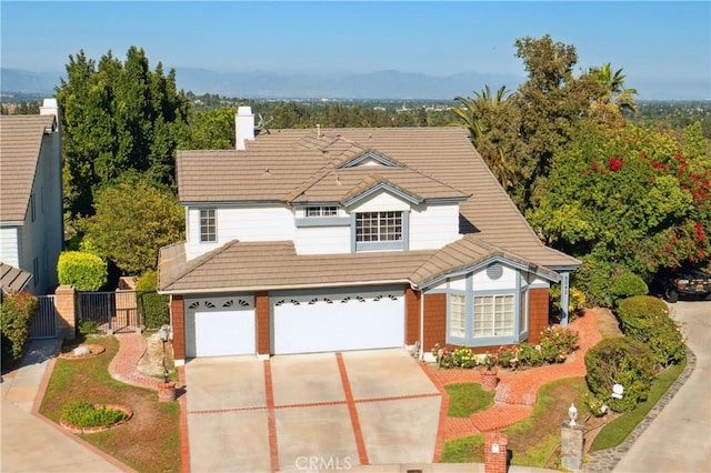 8042 Masefield Ct, West Hills, CA 91304 - traditional home featuring driveway, a tile roof, a chimney, a garage, and a mountain view