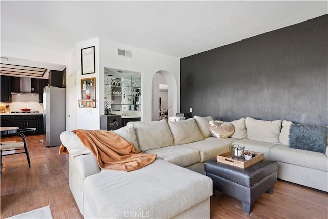 8042 Masefield Ct, West Hills, CA 91304 - living room with arched walkways and wood finished floors