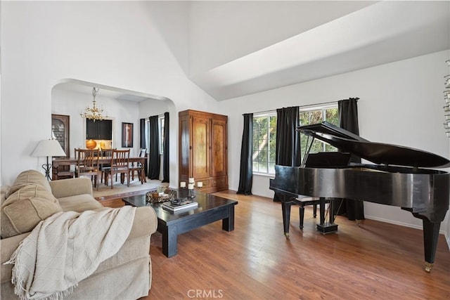 8042 Masefield Ct, West Hills, CA 91304 - living room with a chandelier, arched walkways, wood finished floors, and a high ceiling