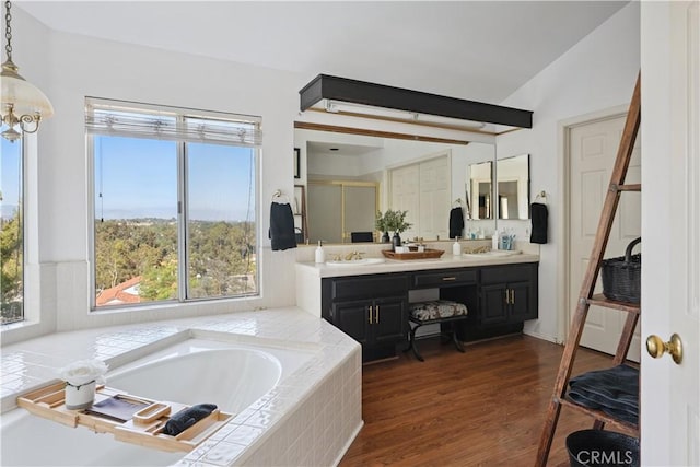 8042 Masefield Ct, West Hills, CA 91304 - full bathroom featuring a garden tub, double vanity, a shower stall, and wood finished floors