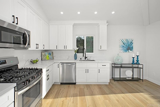 1254 13th St, Imperial Beach, CA 91932 - kitchen featuring appliances with stainless steel finishes, light wood-style flooring, recessed lighting, white cabinets, and light stone countertops