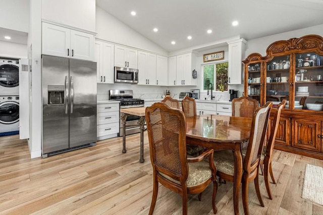 1254 13th St, Imperial Beach, CA 91932 - dining area with stacked washer and clothes dryer, light wood-style floors, recessed lighting, and high vaulted ceiling