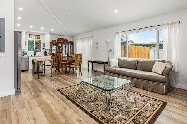 1254 13th St, Imperial Beach, CA 91932 - living room featuring lofted ceiling, recessed lighting, light wood-style floors, decorative columns, and electric panel