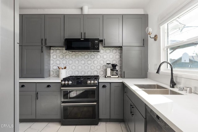 4207 Berenice Ave, Los Angeles, CA 90031 - kitchen with black microwave, range with two ovens, gray cabinetry, tasteful backsplash, and light countertops