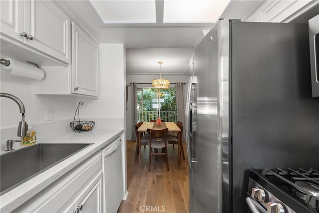 4859 Coldwater Canyon Ave Unit 4, Sherman Oaks, CA 91423 - kitchen with appliances with stainless steel finishes, light wood-style flooring, white cabinets, and hanging light fixtures