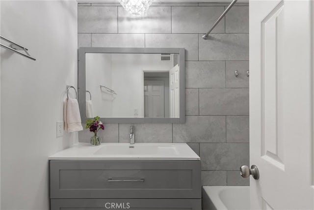 4859 Coldwater Canyon Ave Unit 4, Sherman Oaks, CA 91423 - bathroom featuring vanity, tub / shower combination, and tile walls