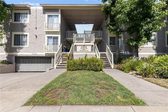 4859 Coldwater Canyon Ave Unit 4, Sherman Oaks, CA 91423 - view of building exterior with stairs, a garage, and driveway