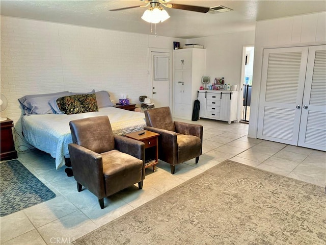 1602 W Dorothea Ave W, Visalia, CA 93277 - bedroom featuring light tile patterned floors, ceiling fan, a closet, and brick wall