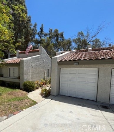 29441 Via La Plz, Murrieta, CA 92563 - view of property exterior featuring concrete driveway, a tile roof, and stucco siding