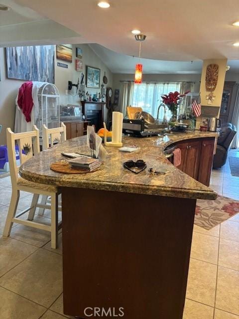 29441 Via La Plz, Murrieta, CA 92563 - kitchen featuring light tile patterned flooring, dark stone countertops, recessed lighting, and hanging light fixtures