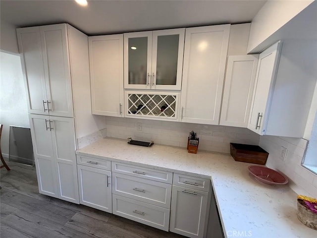 6812 Hyde Park Dr Unit C, San Diego, CA 92119 - kitchen featuring white cabinets, tasteful backsplash, glass insert cabinets, light stone countertops, and dark wood finished floors