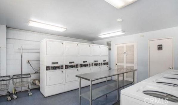 6812 Hyde Park Dr Unit C, San Diego, CA 92119 - kitchen with stacked washer / dryer, white cabinets, and light countertops