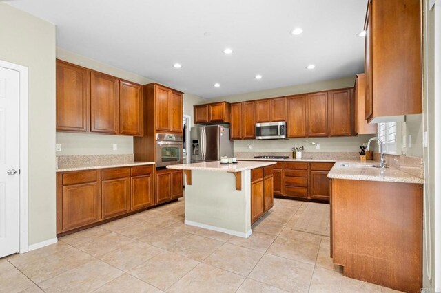 1789 Perrin Pl, Chula Vista, CA 91913 - kitchen featuring stainless steel appliances, brown cabinets, a breakfast bar area, a kitchen island, and recessed lighting