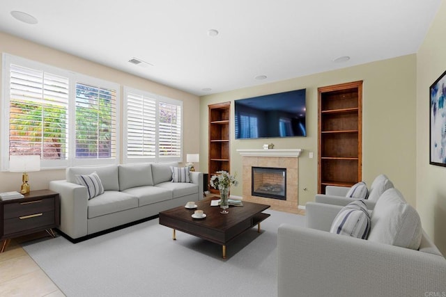 1789 Perrin Pl, Chula Vista, CA 91913 - living area with built in shelves, a tile fireplace, and light tile patterned floors