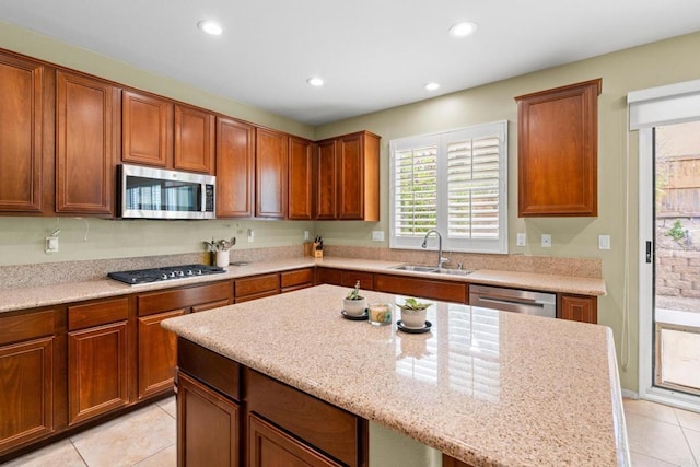 1789 Perrin Pl, Chula Vista, CA 91913 - kitchen with appliances with stainless steel finishes, light tile patterned flooring, recessed lighting, brown cabinets, and light stone counters