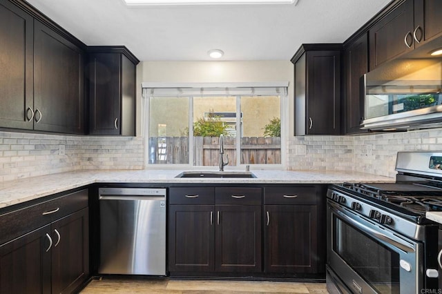 5149 Maplewood Cir, Oceanside, CA 92056 - kitchen with stainless steel appliances, light stone countertops, decorative backsplash, and light wood finished floors
