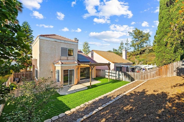 5149 Maplewood Cir, Oceanside, CA 92056 - back of house with a tile roof, stucco siding, roof mounted solar panels, a patio, and a fenced backyard