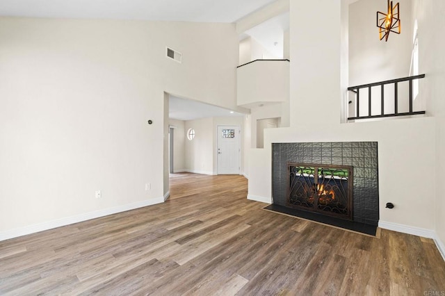 5149 Maplewood Cir, Oceanside, CA 92056 - unfurnished living room with wood finished floors, a fireplace, and high vaulted ceiling
