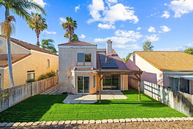 5149 Maplewood Cir, Oceanside, CA 92056 - back of property with stucco siding, roof mounted solar panels, a tiled roof, a chimney, and a patio area
