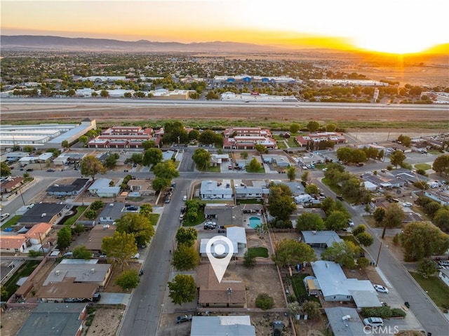2017 W Newgrove St, Lancaster, CA 93536 - aerial overview of property's location featuring a mountain backdrop and nearby suburban area