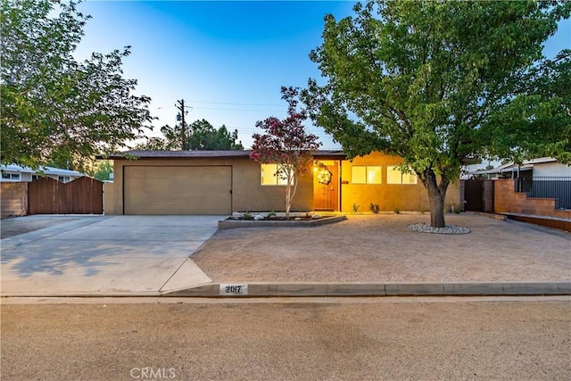 2017 W Newgrove St, Lancaster, CA 93536 - view of front of property featuring concrete driveway, a garage, and stucco siding