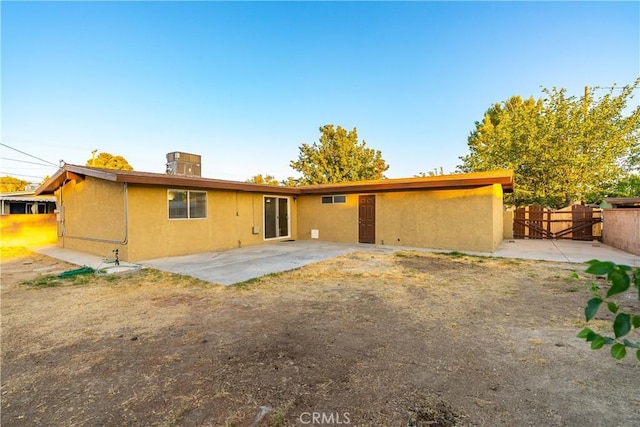 2017 W Newgrove St, Lancaster, CA 93536 - back of property featuring stucco siding, a patio, and a gate