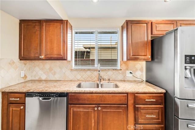 2017 W Newgrove St, Lancaster, CA 93536 - kitchen with stainless steel appliances, tasteful backsplash, and brown cabinets