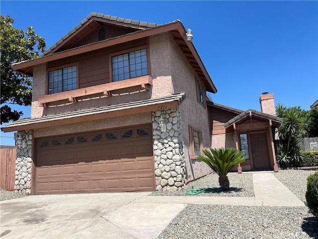7711 Cartilla Ave, Fontana, CA 92336 - view of front of home featuring stone siding, stucco siding, a garage, driveway, and a chimney