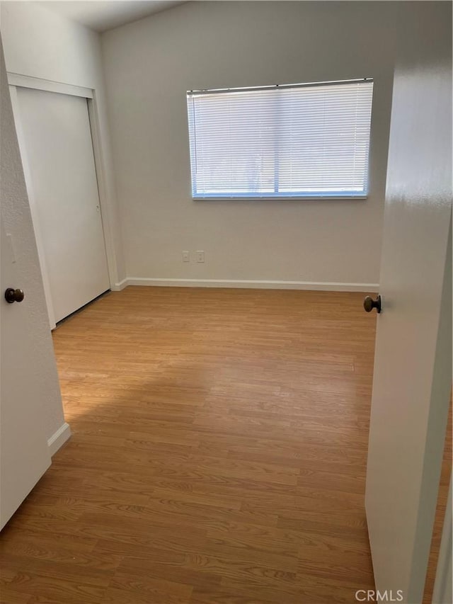 7711 Cartilla Ave, Fontana, CA 92336 - unfurnished bedroom with wood finished floors and a closet