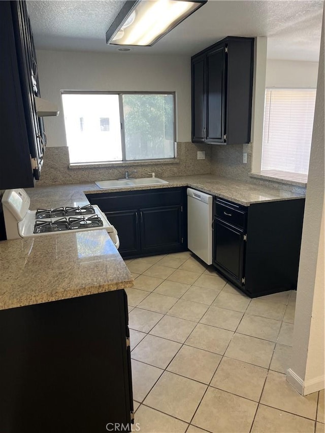 7711 Cartilla Ave, Fontana, CA 92336 - kitchen featuring dishwasher, range, dark cabinetry, and a textured ceiling