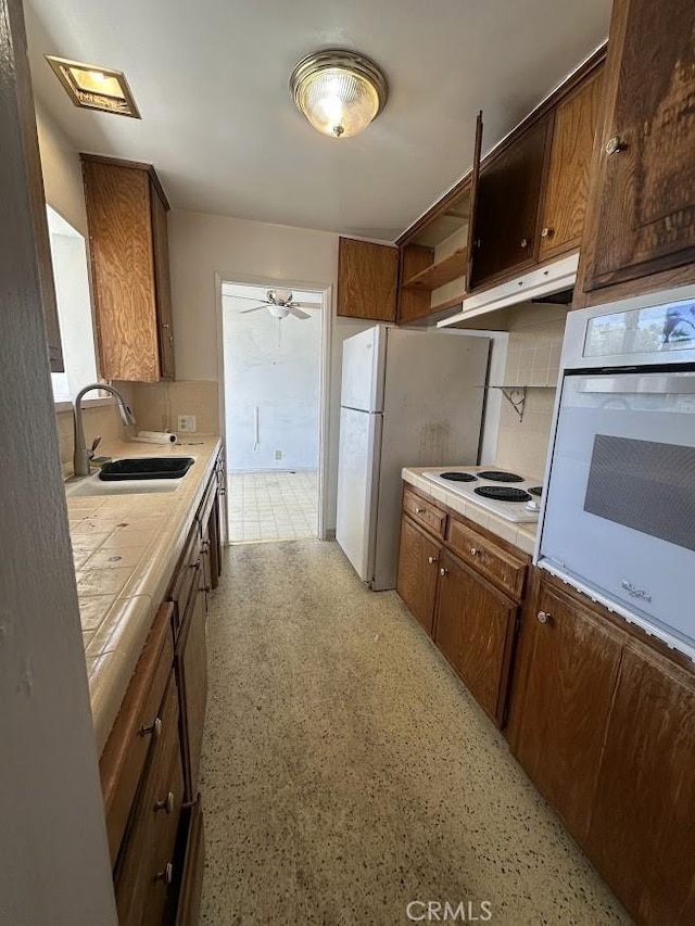 505 Cedar Ave Unit 2A, Long Beach, CA 90802 - kitchen featuring white appliances, tile countertops, open shelves, ceiling fan, and under cabinet range hood