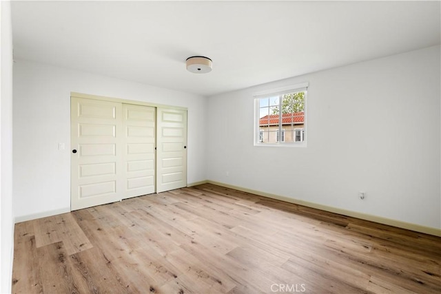 1030 Echo Park Ave, Los Angeles, CA 90026 - unfurnished bedroom featuring wood finished floors and a closet
