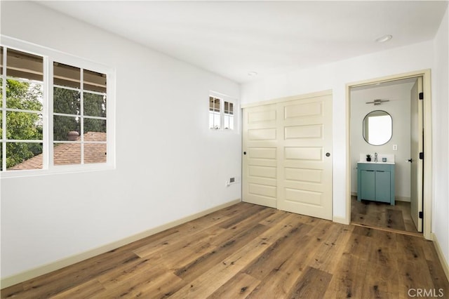 1030 Echo Park Ave, Los Angeles, CA 90026 - unfurnished bedroom with a closet, wood finished floors, and multiple windows