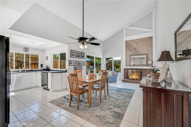 1358 Oakhurst Ct, Camarillo, CA 93010 - dining room featuring a brick fireplace, a skylight, high vaulted ceiling, and a ceiling fan