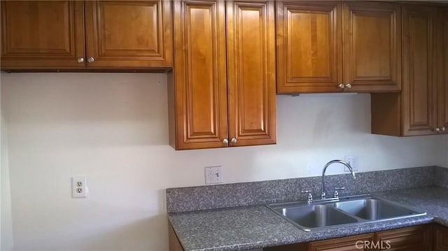 12071 Laguna St, Garden Grove, CA 92840 - kitchen featuring dark countertops and brown cabinetry
