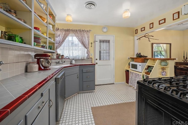 4886 Twain Ave, San Diego, CA 92120 - kitchen with tile countertops, gray cabinets, white microwave, and tasteful backsplash